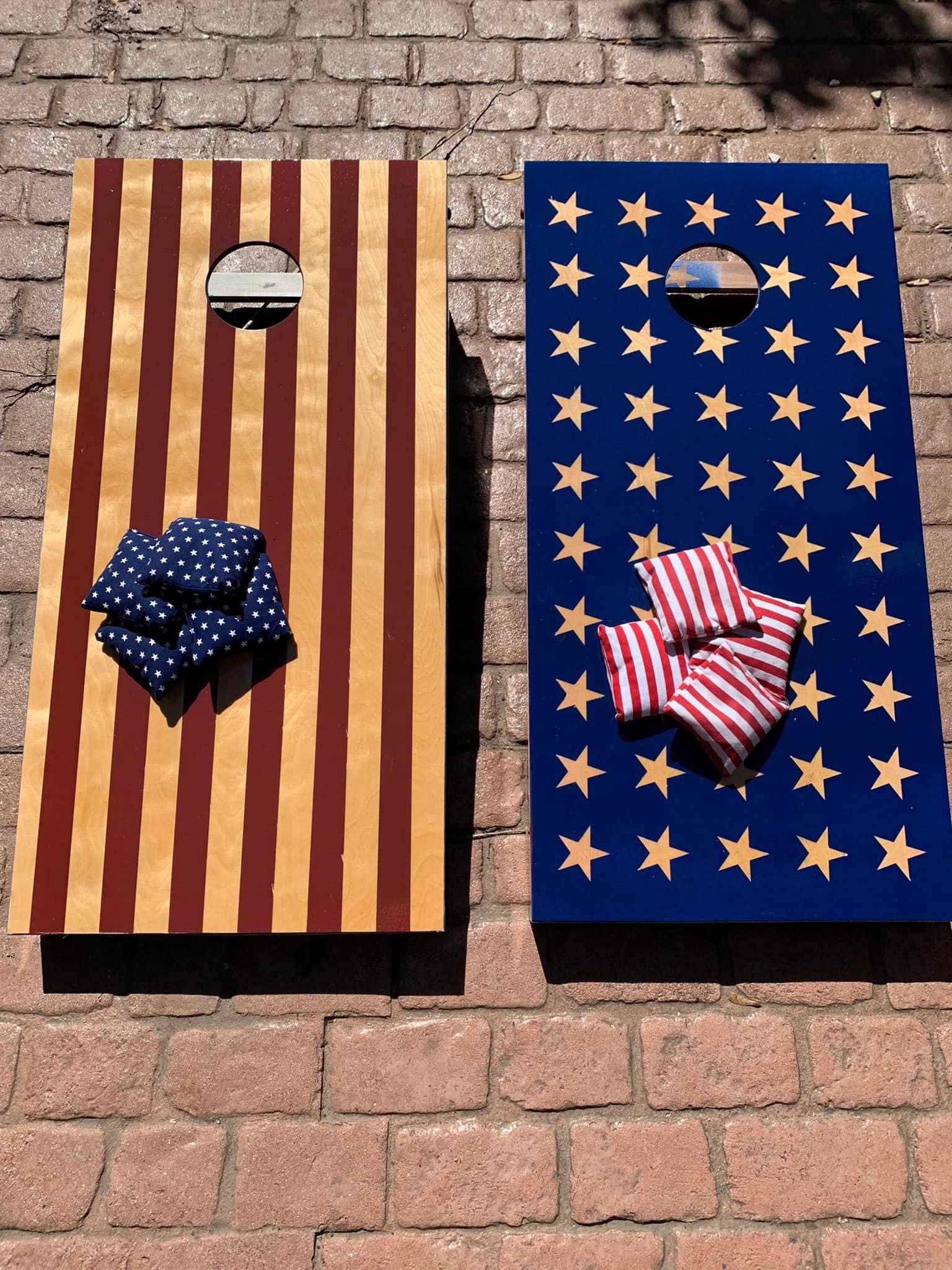 Stars and stripes cornhole board set with maple star inlay, mounted for display